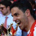 Arsenal manager Mikel Arteta bites the Premier League trophy