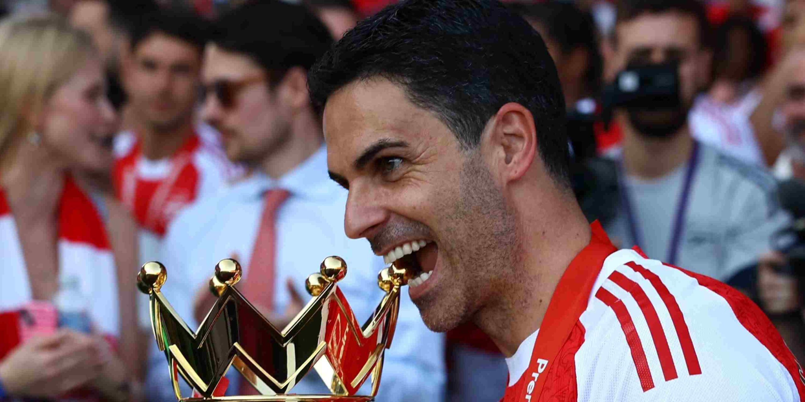 Arsenal manager Mikel Arteta bites the Premier League trophy