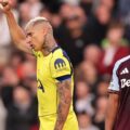Richarlison holds his hand high after scoring for Tottenham against Aston Villa