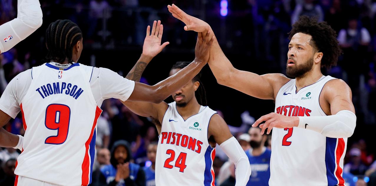 Detroit Pistons players celebrate after scoring against Orlando Magic