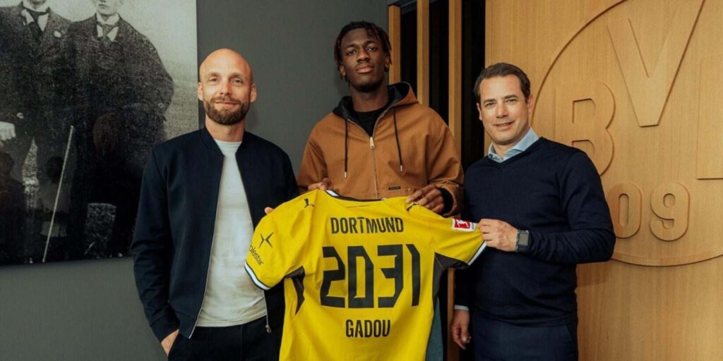 Joane Gadou posing with Borussia Dortmund shirt