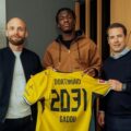 Joane Gadou posing with Borussia Dortmund shirt