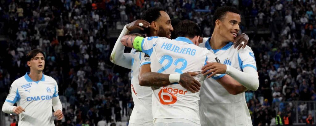 Marseille players celebrate after scoring against Rennes