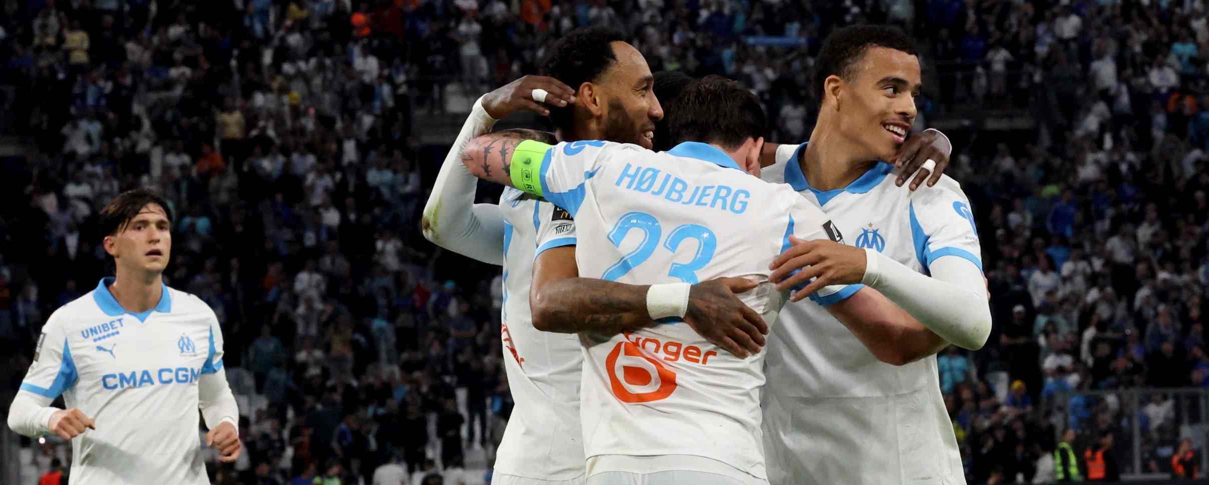 Marseille players celebrate after scoring against Rennes