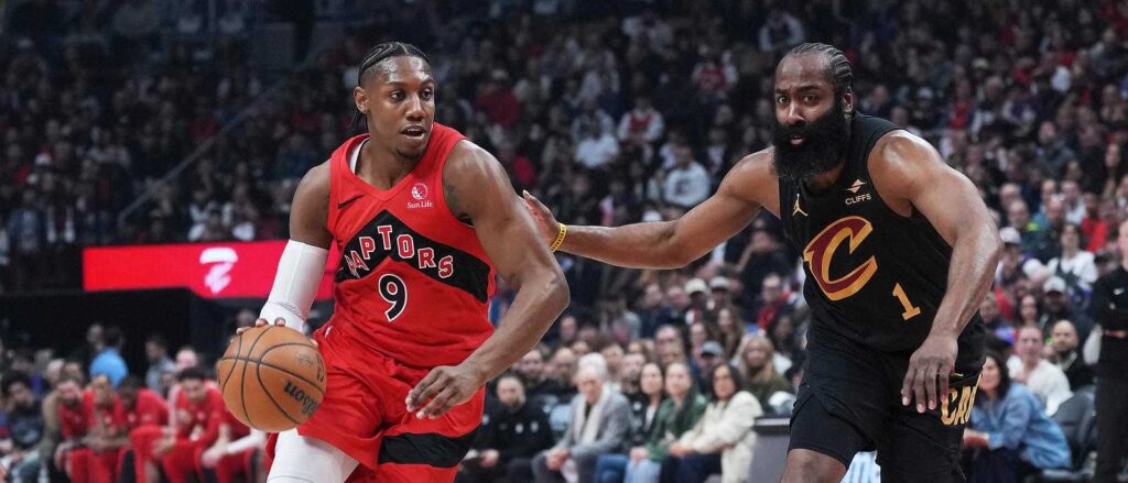 RJ Barrett dribbles the ball guarded by James Harden