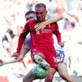 An opponent holding Alexis Mac Allister