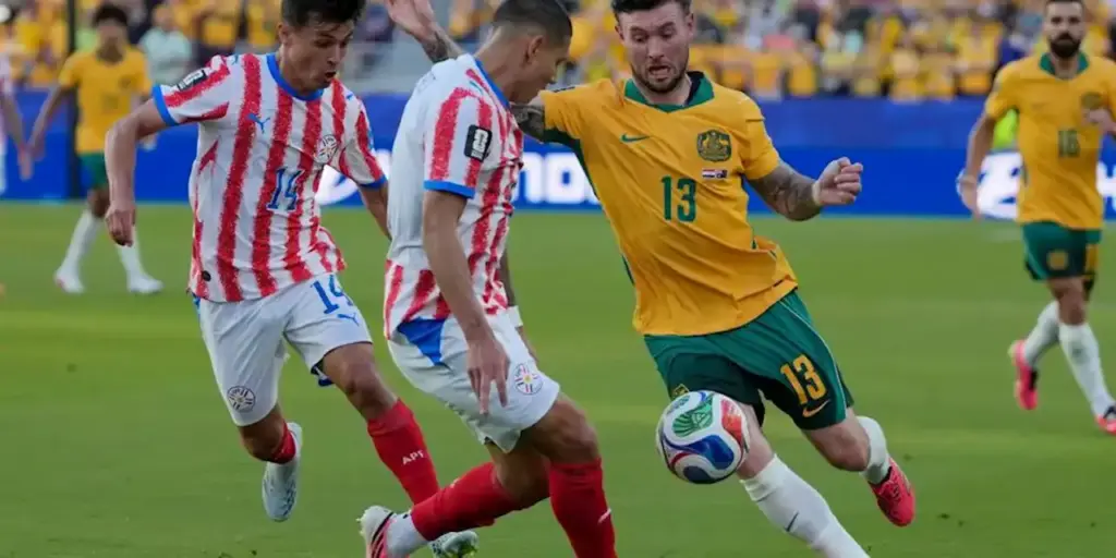 Australia and Paraguay players in a battle for the ball