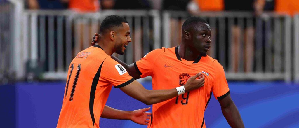 Brian Brobbey and Cody Gakpo celebrate after scoring against Sweden