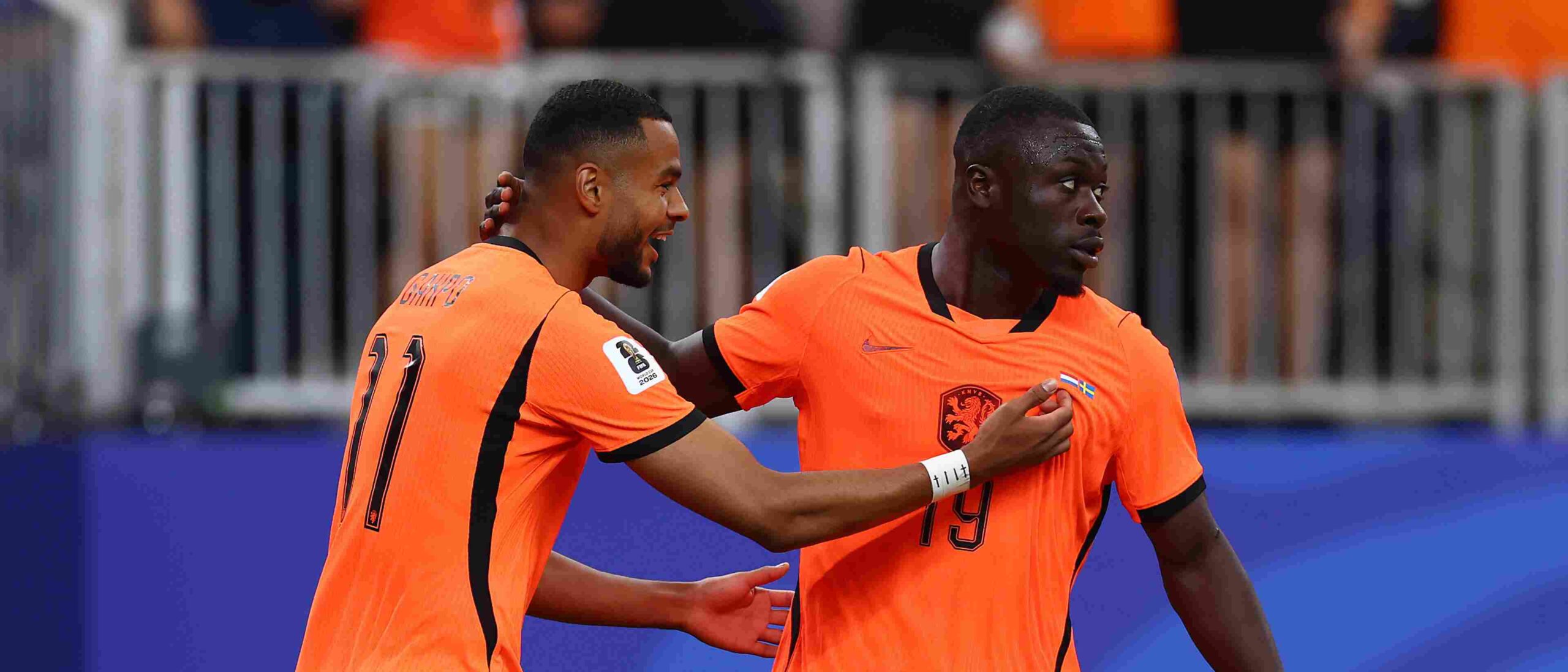 Brian Brobbey and Cody Gakpo celebrate after scoring against Sweden