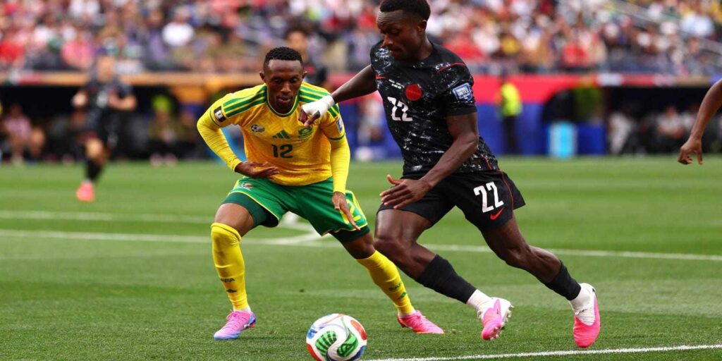 Canada player trying to evade the defence of South African opponent