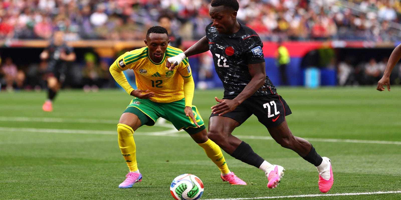 Canada player trying to evade the defence of South African opponent
