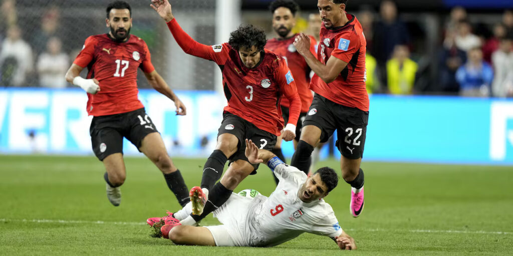 Egypt and Iran players in a battle for the ball