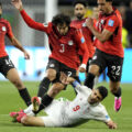 Egypt and Iran players in a battle for the ball