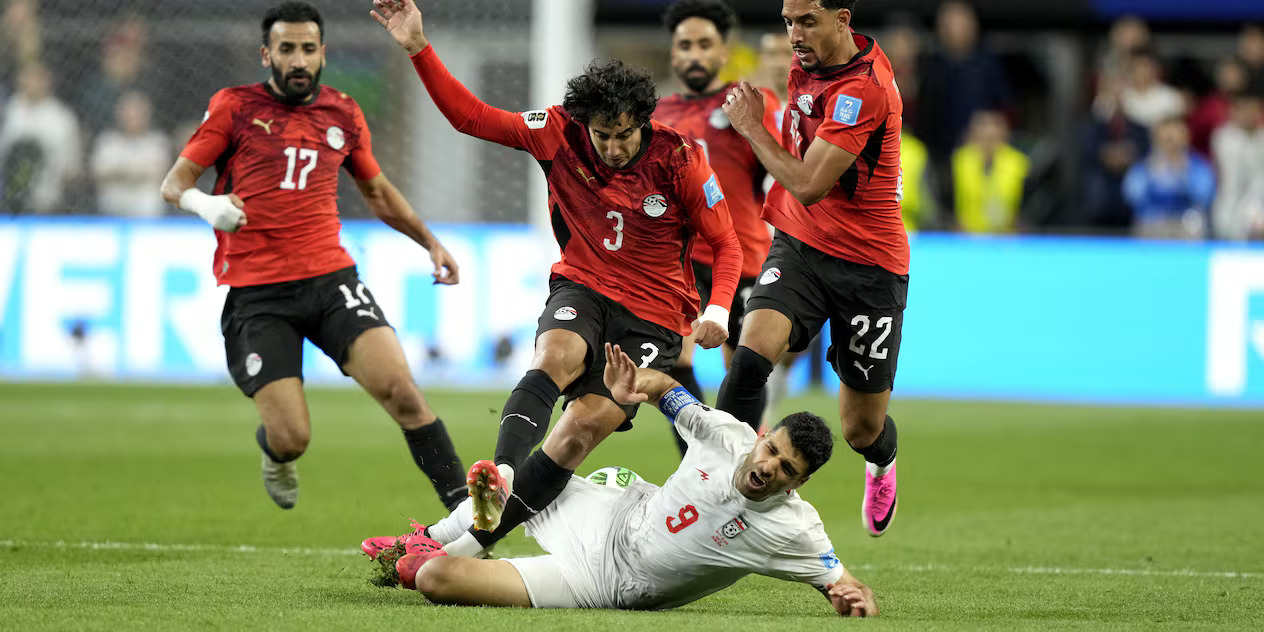 Egypt and Iran players in a battle for the ball