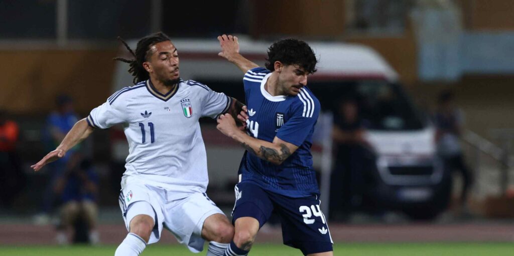 Greece and Italy players in a battle for the ball