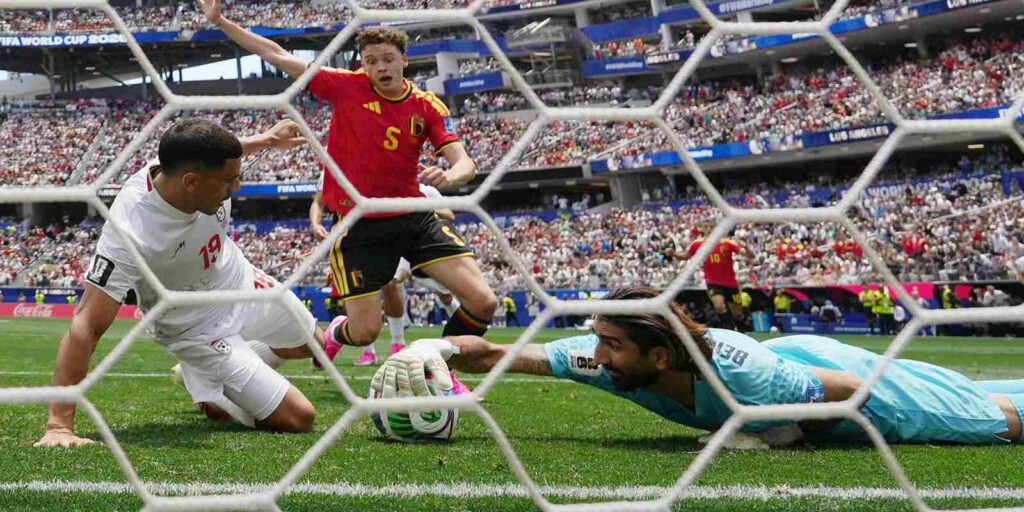 Iran goalkeeper stops the ball just before the goal line in the match against Belgium