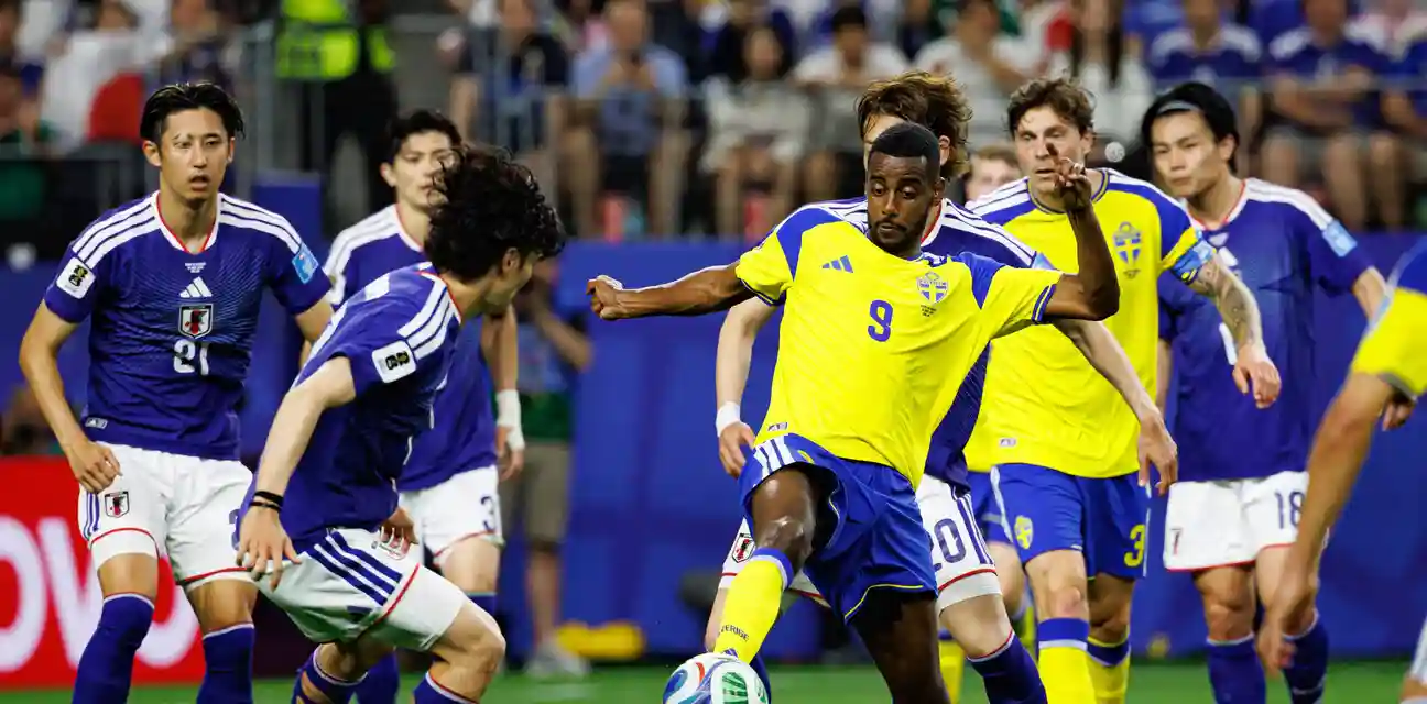 Alexander Isak in a battle for the ball with Japanese opponents
