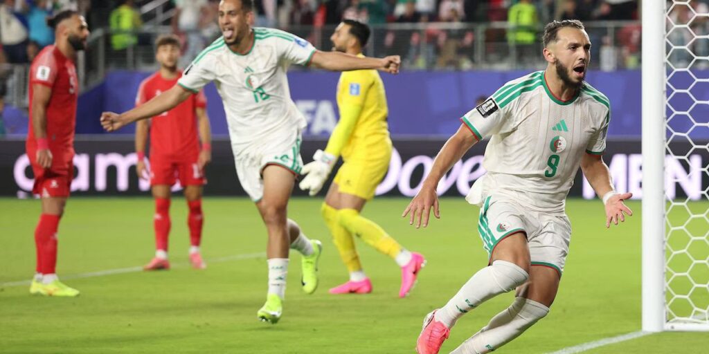 Algerian players celebrate after scoring against Jordan