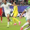 Algerian players celebrate after scoring against Jordan