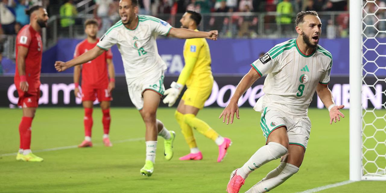 Algerian players celebrate after scoring against Jordan