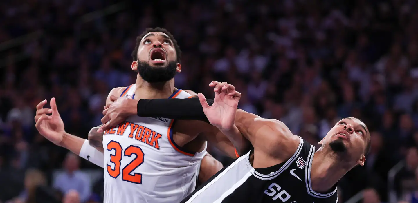 Victor Wembanyama and Karl-Anthony Towns in a battle for the ball