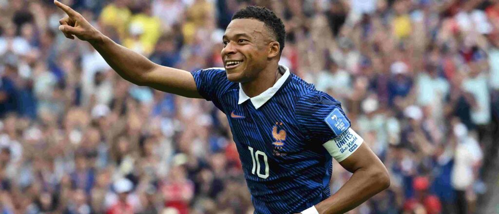 Kylian Mbappe celebrates after scoring against Iraq