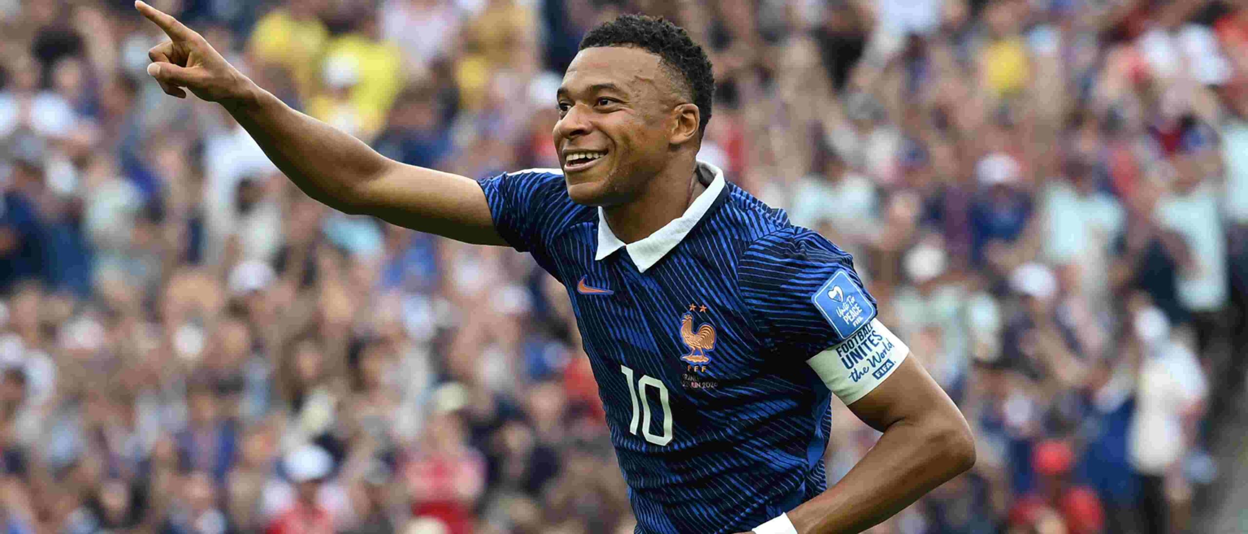 Kylian Mbappe celebrates after scoring against Iraq