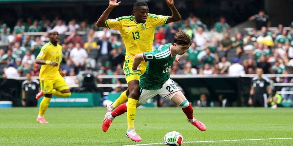 South Africa's Yaya Sithole commits a foul on Mexico player