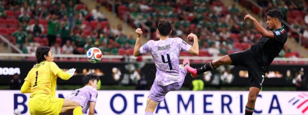 Mexican player shoots toward South Korea's goal