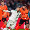 Memphis Depay and Anis Hadj Moussa in a battle for the ball