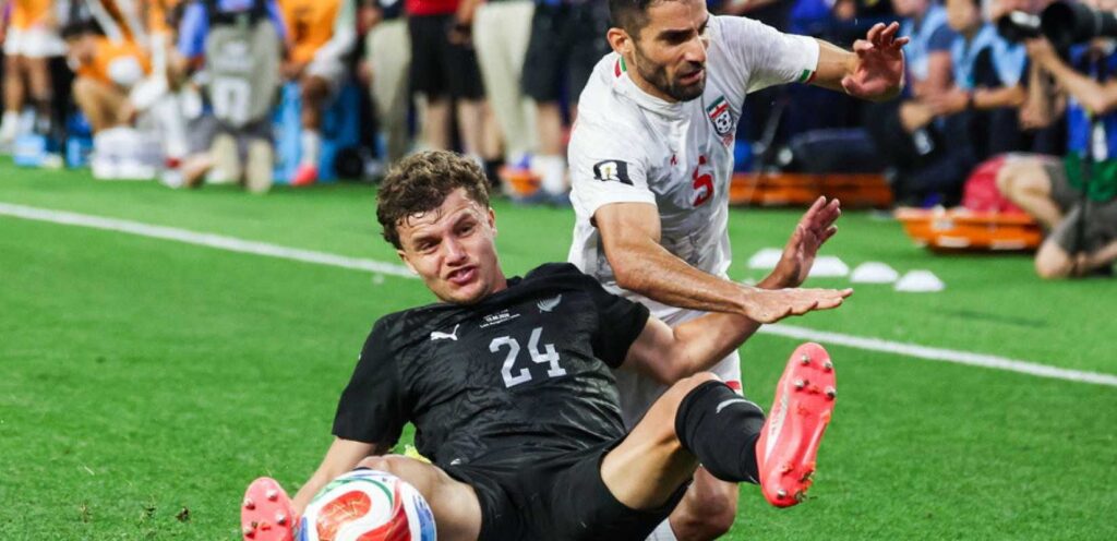 New Zealand and Iran players in a battle for the ball