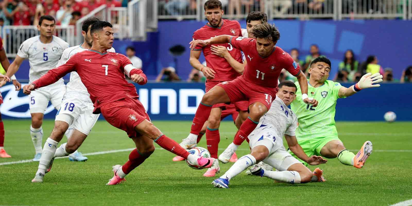 Uzbekistan players trying to prevent Cristiano Ronaldo from scoring
