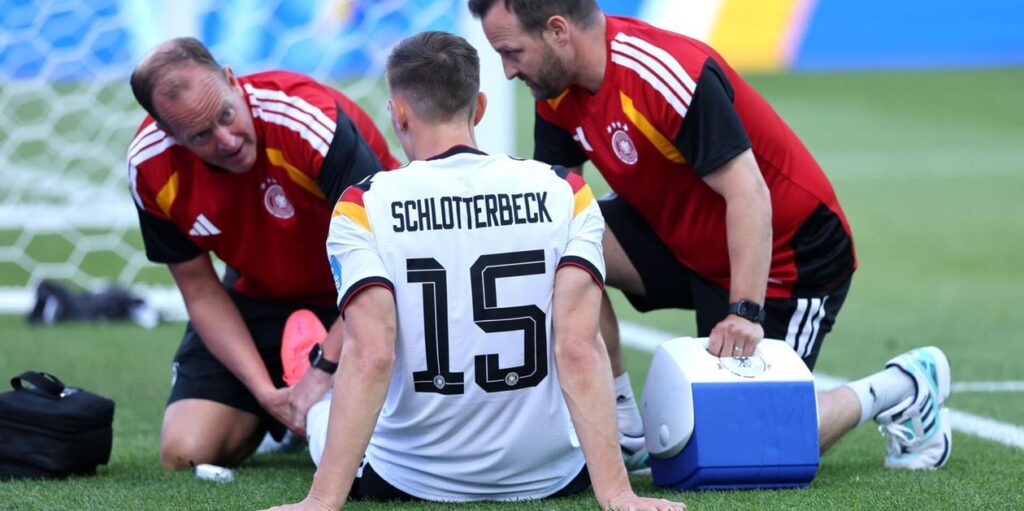 Nico Schlotterbeck receiving treatment for an injury during the World Cup