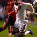 Spain and Peru players in a battle for the ball