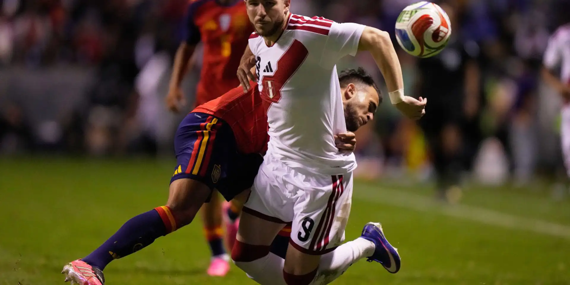 Spain and Peru players in a battle for the ball