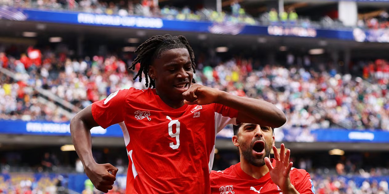 Swiss players rush to celebrate after scoring against Bosnia and Herzegovina