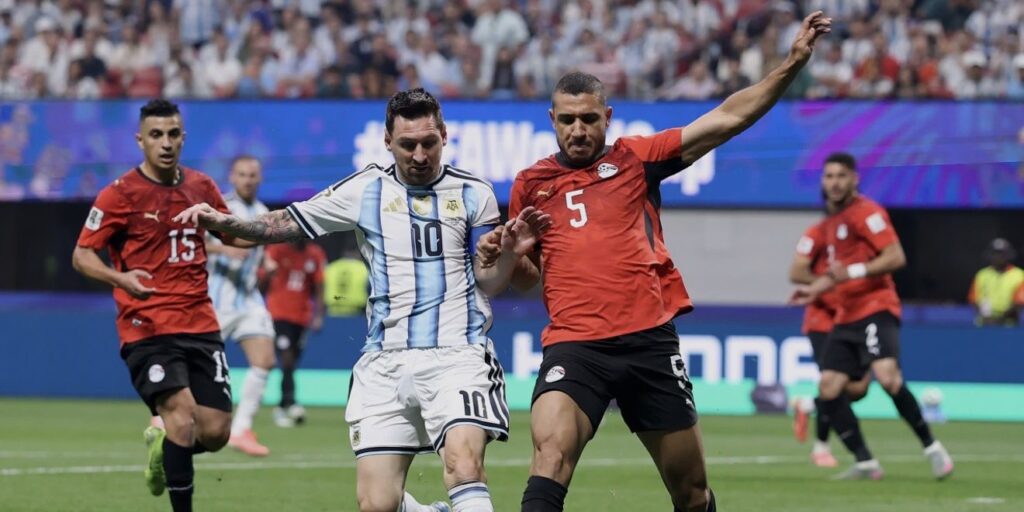 Lionel Messi in a battle for the ball with an Egypt opponent