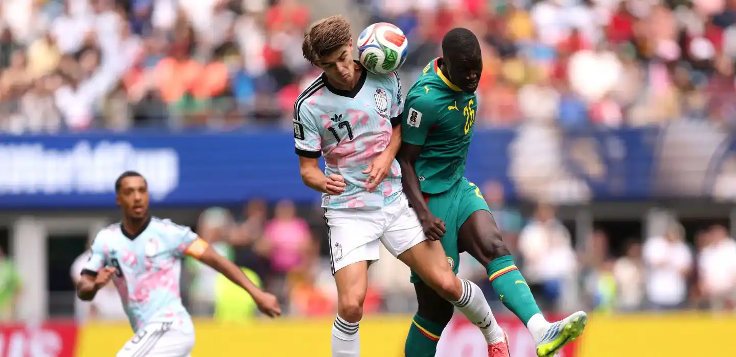 Belgium and Senegal players in a battle for a high ball