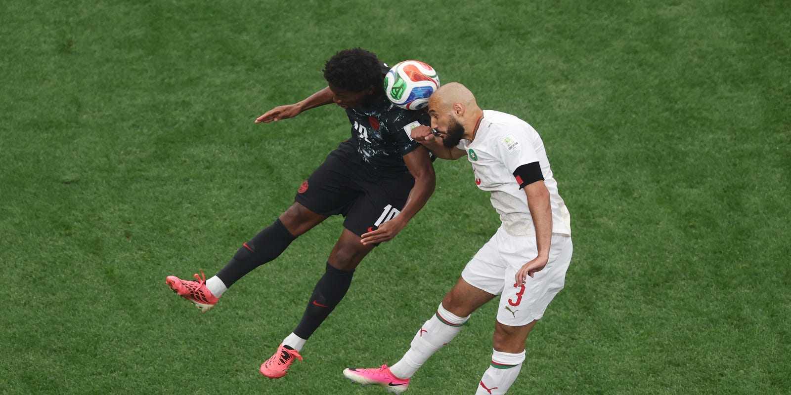 Canada and Morocco players in a battle for a high ball
