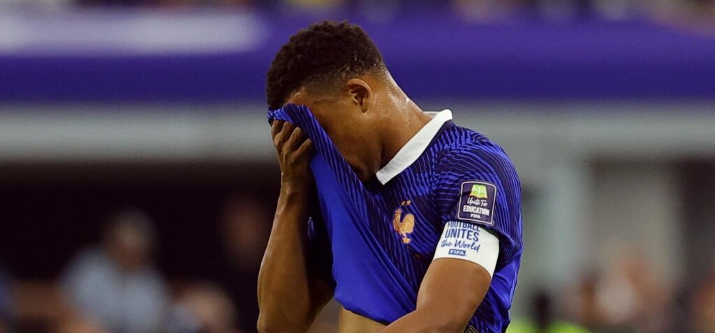Kylian Mbappe hides his face in disappointment