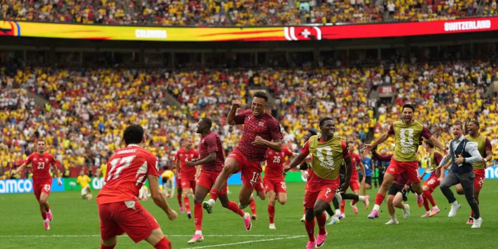 Switzerland players celebrate after winning penalty shootout against Colombia