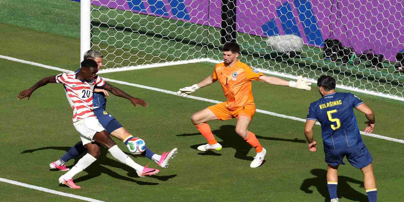 Bosnia and Herzegovina player blocking Folarin Balogun's shot