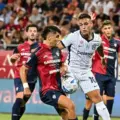 Cagliari player trying to stop Inter captain Lautaro Martinez