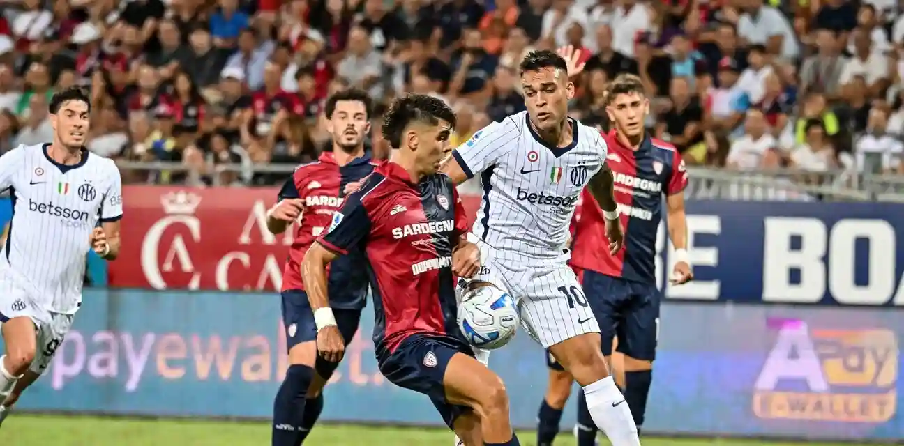 Cagliari player trying to stop Inter captain Lautaro Martinez