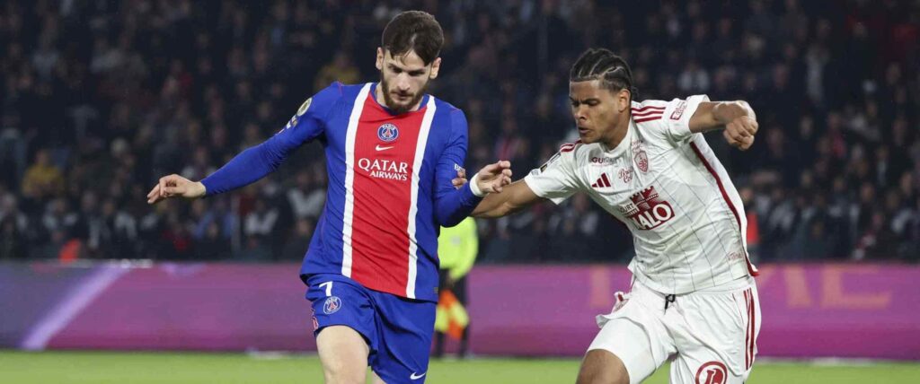 Khvicha Kvaratskhelia and Raphael Le Guen in a battle for the ball