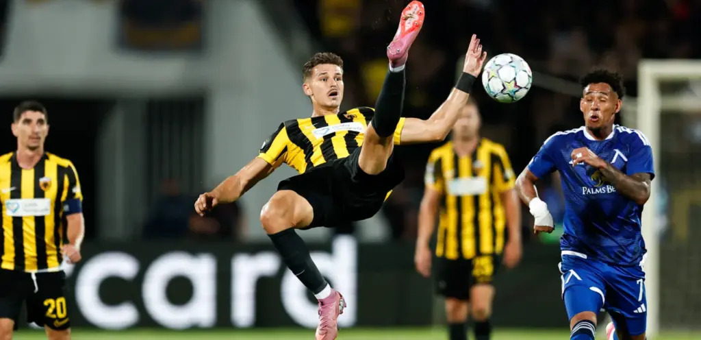 AEK player trying to clear the ball ahead of Levski forward