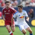 Liverpool and Leeds players in a battle for the ball during a friendly match