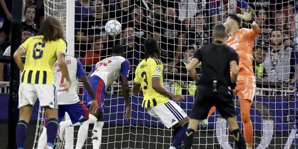 Lyon player heads the ball towards Fenerbahce's goal