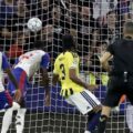 Lyon player heads the ball towards Fenerbahce's goal