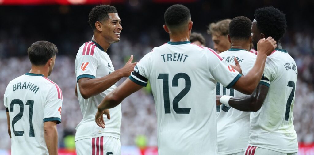 Real Madrid players congratulate one another after scoring against Malaga